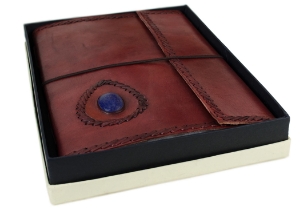 Leather and stone are a magic combination, made durable by nature and authentic by our design. Our Ra collection of leather journals features a stone motif to create an energetic and visible impact. The Lapis Lazuli is the eye of inner power and represents wisdom and enlightenment of the mind. This carefully selected, midnight blue semi-precious stone is aesthetically embedded in rugged, yet soft and supple buffalo hide. Beautifully contoured with hand stitched leather cord around the stone and journal to create a dimensional frame and intrepid feel. The exposed spine binding is pure leather cord which has been hand sewn to hold the pages in place and will certainly stand the test of the time.