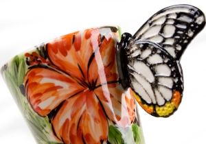 A beautiful ethereal Butterfly resting on a gorgeous Blue Witch ceramic coffee mug. Butterflies are fascinating creatures, with its humble beginnings as the caterpillar to its truly astonishing metamorphosis into the airborne butterfly.
