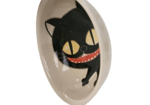 An eye catching feline takes the starring role on our Blue Witch Coraline ceramic collection.Each Bowl is ingeniously hand illustrated by a prolific artist. The canny brush strokes and cunning design create a curiosity with an air of mystery. Each piece is hand tooled to form a slightly eccentric asymmetrical shape. Visually and audibly theatrical whilst great for everyday use, dishwasher safe and microwave friendly to guarantee the colour will never fade.  It will also add a magical charm to a dinner party. Guaranteed to make the kids ‘Meow’ with delight and full of joie de vivre at any fun theme party!