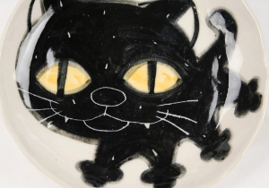 An eye catching feline takes the starring role on our Blue Witch Coraline ceramic collection.Each Plate is ingeniously hand illustrated by a prolific artist. The canny brush strokes and cunning design create a curiosity with an air of mystery. Each piece is hand tooled to form a slightly eccentric asymmetrical shape. Visually and audibly theatrical whilst great for everyday use, dishwasher safe and microwave friendly to guarantee the colour will never fade.  It will also add a magical charm to a dinner party. Guaranteed to make the kids ‘Meow’ with delight and full of joie de vivre at any fun theme party!