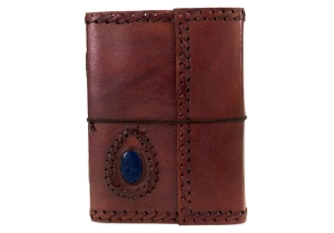 Leather and stone are a magic combination, made durable by nature and authentic by our design. Our Ra collection of leather journals features a stone motif to create an energetic and visible impact. The Lapis Lazuli is the eye of inner power and represents wisdom and enlightenment of the mind. This carefully selected, midnight blue semi-precious stone is aesthetically embedded in rugged, yet soft and supple buffalo hide. Beautifully contoured with hand stitched leather cord around the stone and journal to create a dimensional frame and intrepid feel. The exposed spine binding is pure leather cord which has been hand sewn to hold the pages in place and will certainly stand the test of the time.