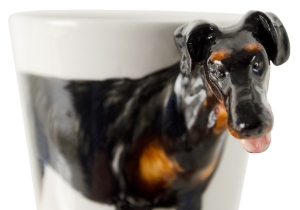 A beautiful handmade Blue Witch ceramic featuring the sleek and elegant Doberman. This fearless animal is renowned for its prowess as a guard dog.