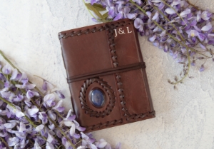 Leather and stone are a magic combination, made durable by nature and authentic by our design. Our Ra collection of leather journals features a stone motif to create an energetic and visible impact. The Lapis Lazuli is the eye of inner power and represents wisdom and enlightenment of the mind. This carefully selected, midnight blue semi-precious stone is aesthetically embedded in rugged, yet soft and supple buffalo hide. Beautifully contoured with hand stitched leather cord around the stone and journal to create a dimensional frame and intrepid feel. The exposed spine binding is pure leather cord which has been hand sewn to hold the pages in place and will certainly stand the test of the time.